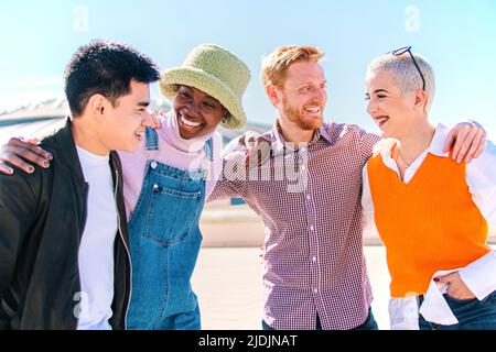 Group of four friends laughing out loud outdoor. Two couples talking and enjoying a good day Stock Photo