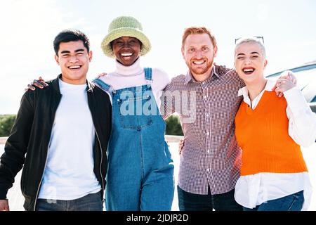 Portrait of a happy multiracial group of smiling friends. Young people laughing and having fun in the park on a sunny day Stock Photo