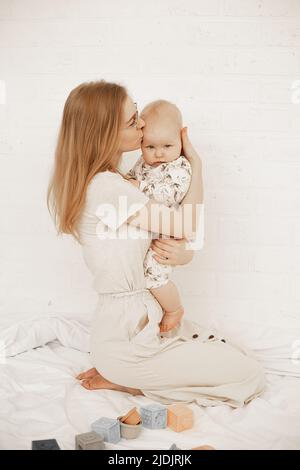Cute little baby sitting near potty on white background Stock Photo - Alamy