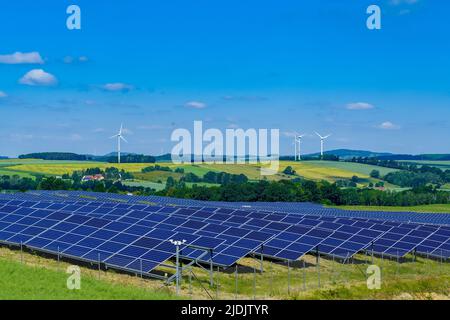 Wind turbines and solar power plant during sunny day Stock Photo
