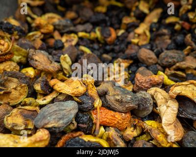 Background from dried fruits. Lots of dried fruits. Diet. Filling for compote. Dried fruit box. Dried apple pieces, apricots Stock Photo