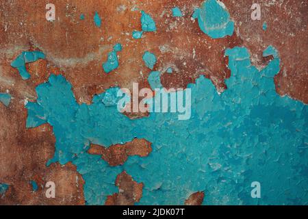 Brown-blue color of peeling cracked paint on the old wall. For texture or background, pattern. Soft Selective focus Stock Photo