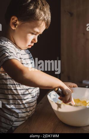 Premium Photo  A funny cute toddler mixing ingredients using blender  helping father a kid learning to cook