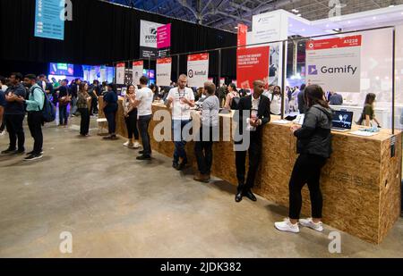 Toronto, Canada. 21st June, 2022. People visit startup booths during the 2022 Collision Conference in Toronto, Canada, on June 21, 2022. The 2022 Collision Conference is held here from June 20 to 23 with more than 1,500 startups from around the world. Credit: Zou Zheng/Xinhua/Alamy Live News Stock Photo