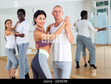 Young couples practicing active dance in pair Stock Photo