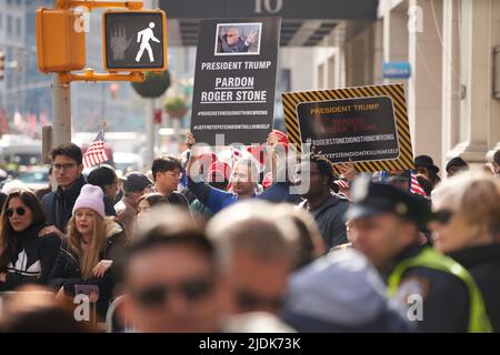 Manhattan, New York,USA - November 11. 2019: Pardon Roger Stone signs held up during Veterans Day Parade in NYC. Call for President Trump to pardon Ro Stock Photo