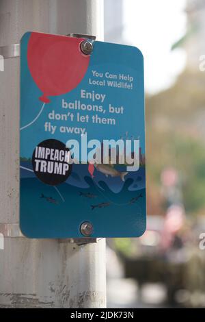 Manhattan, New York, USA - November 11. 2019: Sign calling for protection of local Wildlife in NYC, Impeach Trump sticker on sign. Sign post on pole d Stock Photo
