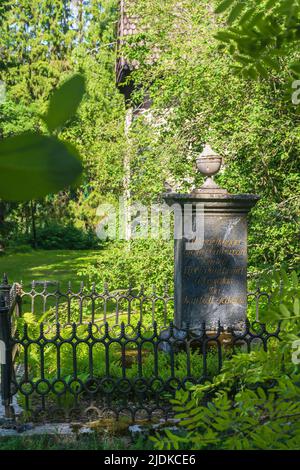 Stone column at an old family grave at churchyard of an old medieval stone church in Messukylä Tampere Finland Stock Photo