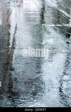 wet asphalt road after rain with sky reflections. rainy weather in the city. Stock Photo