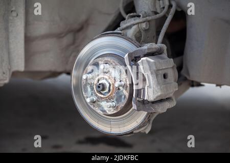 Disc brake of the vehicle for repair, in process of tire replacement Stock Photo