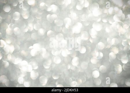 Abstract silver bokeh background, defocused blurry sparkles with vignette around the edges. Beautiful shiny background with highlights and sparkles on Stock Photo
