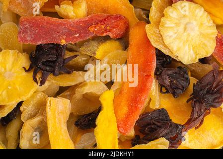 Mix of dried exotic fruit, mangos,slices of pineapples, passion fruit, papaya. Vegetarian dessert. Stock Photo
