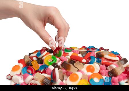 Woman hand takes a jelly candy on a white background. Stock Photo