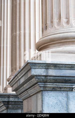 Low angled, tight crop view of architectural  Greek - Roman style columns on plinths standing side by side. Stock Photo