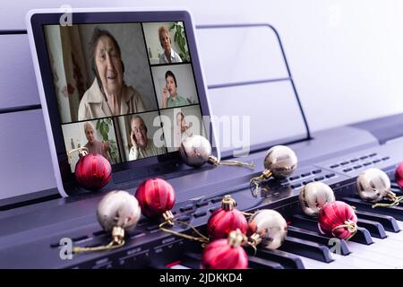 Black and white piano keys and tablet on a black isolated background. Close-up, banner. The concept of online courses of the game fortepiano Stock Photo