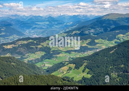 Valley in the Alps with fields and mountains Stock Photo