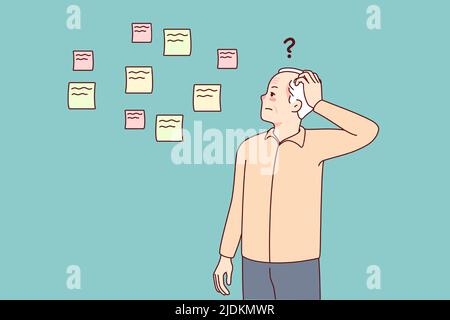 Elderly man making notes suffering from memory loss. Old grandfather ...