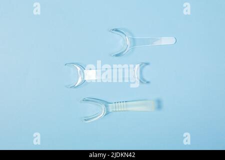 set of several Retractor Dental lip retractor Access to the oral cavity. Wide mouth opening for a dental procedure on a blue background Stock Photo