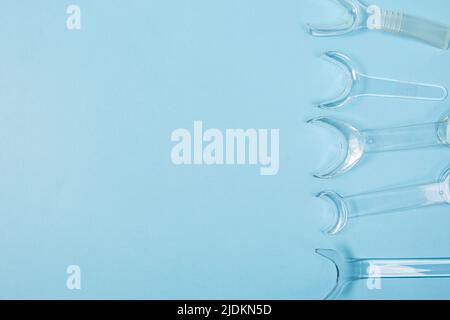 set of several Retractor Dental lip retractor Access to the oral cavity. Wide mouth opening for a dental procedure on a blue background Stock Photo