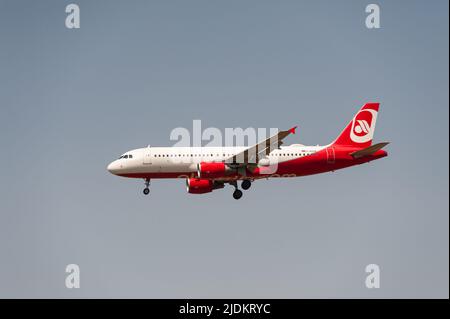 18.06.2022, Berlin, Germany, Europe - A Sundair Airbus A320-200 passenger aircraft in Air Berlin livery approaches BER Airport for landing. Stock Photo