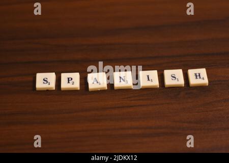 Selective focused close up shot of Spanish word. Made by using the letters in blocks in a wooden background. Stock Photo