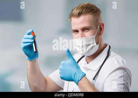 young medical doctor with a blood probe in laboratory Stock Photo
