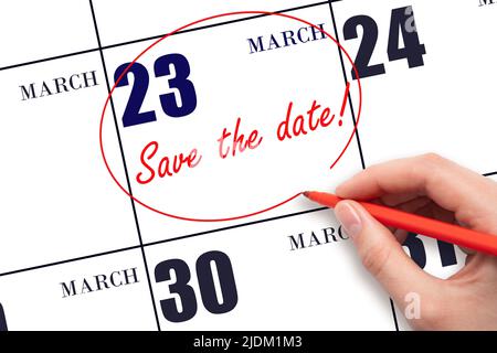 23rd day of March. Hand drawing red line and writing the text Save the date on calendar date March 23. Spring month, day of the year concept. Stock Photo