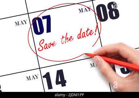 7th day of May. Hand drawing red line and writing the text Save the date on calendar date May 7. Spring month, day of the year concept. Stock Photo