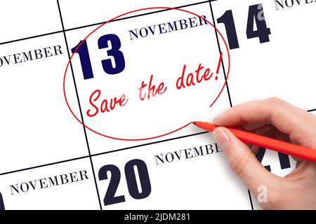 13th day of November. Hand drawing red line and writing the text Save the date on calendar date November 13.  Autumn month, day of the year concept. Stock Photo