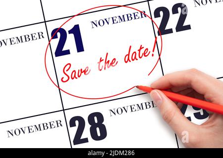 21st day of November. Hand drawing red line and writing the text Save the date on calendar date November 21.  Autumn month, day of the year concept. Stock Photo