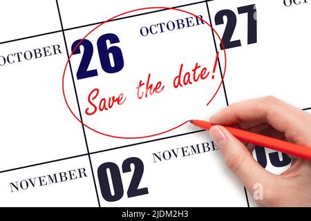 26th day of October. Hand drawing red line and writing the text Save the date on calendar date October 26. Autumn month, day of the year concept. Stock Photo