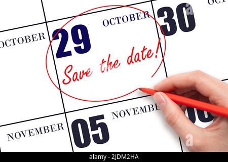 29th day of October. Hand drawing red line and writing the text Save the date on calendar date October 29. Autumn month, day of the year concept. Stock Photo