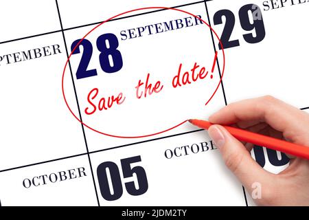 28th day of September. Hand drawing red line and writing the text Save the date on calendar date September 28. Autumn month, day of the year concept. Stock Photo