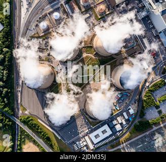 Aerial top down view of a group of cooling towers emitting steam at a large coal fired power station Stock Photo