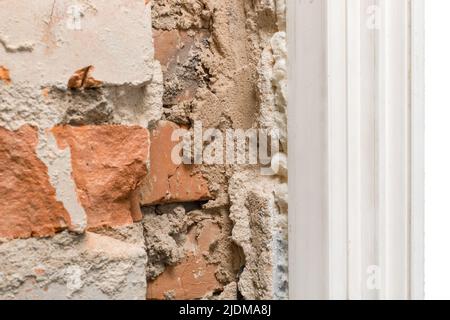 Old brick fragment of unfinished construction repair and reconstruction of the wall close-up. Stock Photo