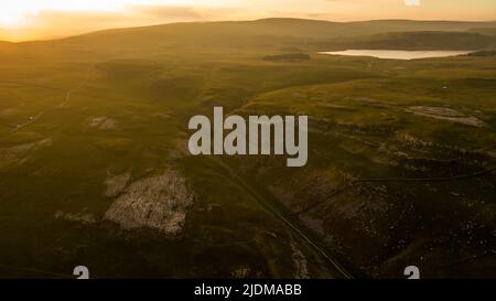 A drone shot of the limestone outcrop Comb Hill and surrounding area around of Malham and Malham Tarn Stock Photo