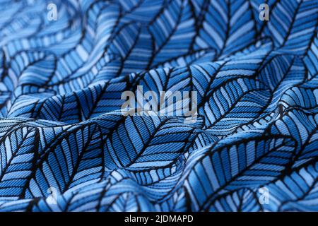Blue crumpled fabric with leaves print textured background Stock Photo