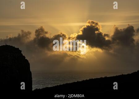 A man photographs the Sunset of Neist Point Lighthouse Isle of Skye Scotland Stock Photo