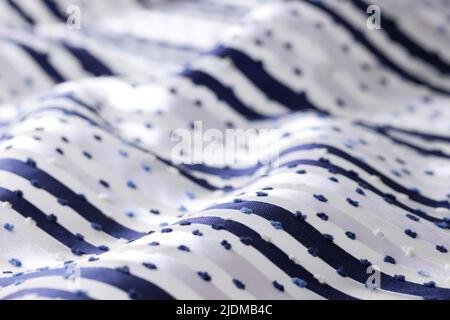 White fabric with dark stripes and dots Stock Photo