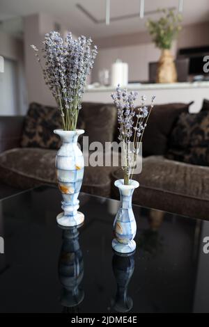 Bouquets of aromatic dried lavender or lavandin flowers in beautiful vases Stock Photo