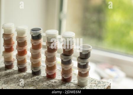 Paint in small jars. Different paint tones. Watercolor for painting. Drawing kit details. Stock Photo