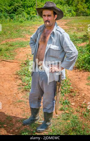 Cuban tobacco farmer with hat, cigar and a machete on a tobacco farm in Viñales, Cuba Stock Photo