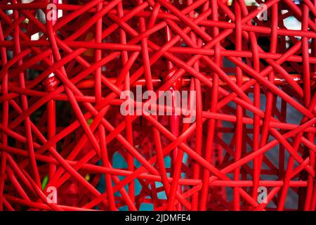 Artistic interior decoration with handmade red color rattan and bamboo wicker weave of classic art and crafts furniture background Stock Photo