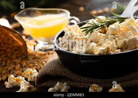 Popcorn  in cast iron skillet with melted butter aside Stock Photo
