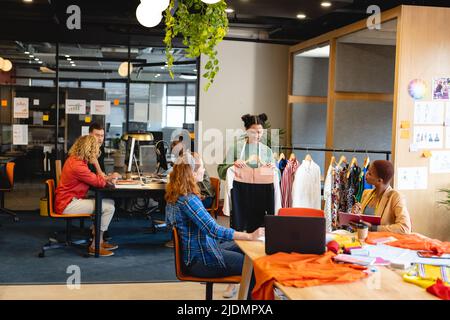 Multiracial male and female fashion designers working in office studio Stock Photo