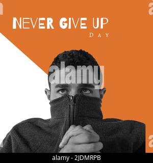 Digital composite image of worried caucasian man hiding face in jacket with never give up day text Stock Photo