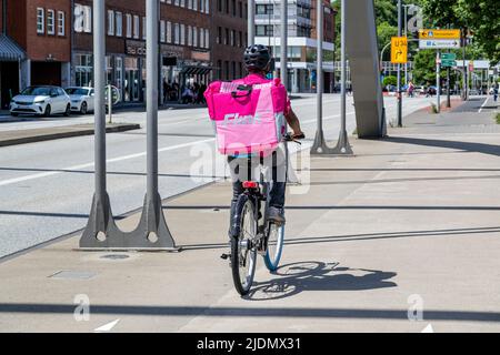 Flink on-demand delivery service courier on bike Stock Photo