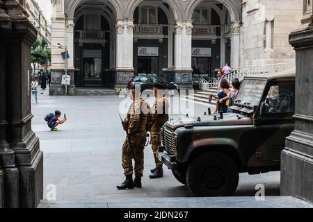 Naples, Italy. May 27, 2022. Two soldiers, a military vehicle and a kid taking a photograph on the square in front of The Naples Cathedral (Duomo di N Stock Photo