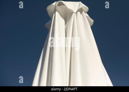 White umbrella on veranda. Sun protection. Stock Photo