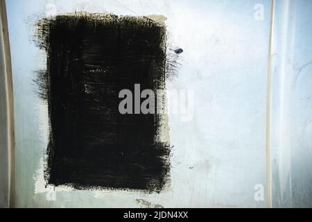 Black spot. Painted over graffiti. Black Square in Street Art. Layer of paint on label. Stock Photo